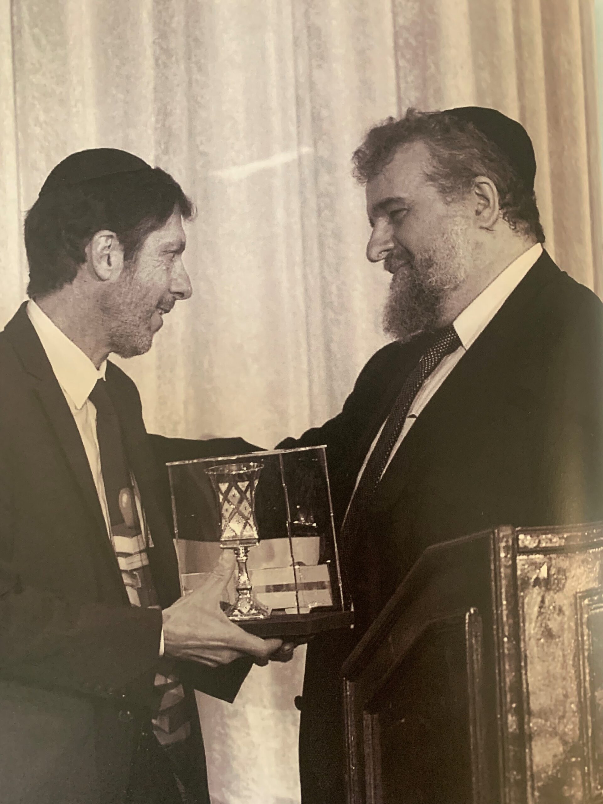 Rabbi Yitzchak Zweig, President of the Talmudic University consortium of schools, announces Dr. Karp as the re
