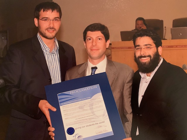 Partnering with local businesses such as Euphoria Water. Pictured here is Rabbi Zalman Lipskar and Dovy Ainswo